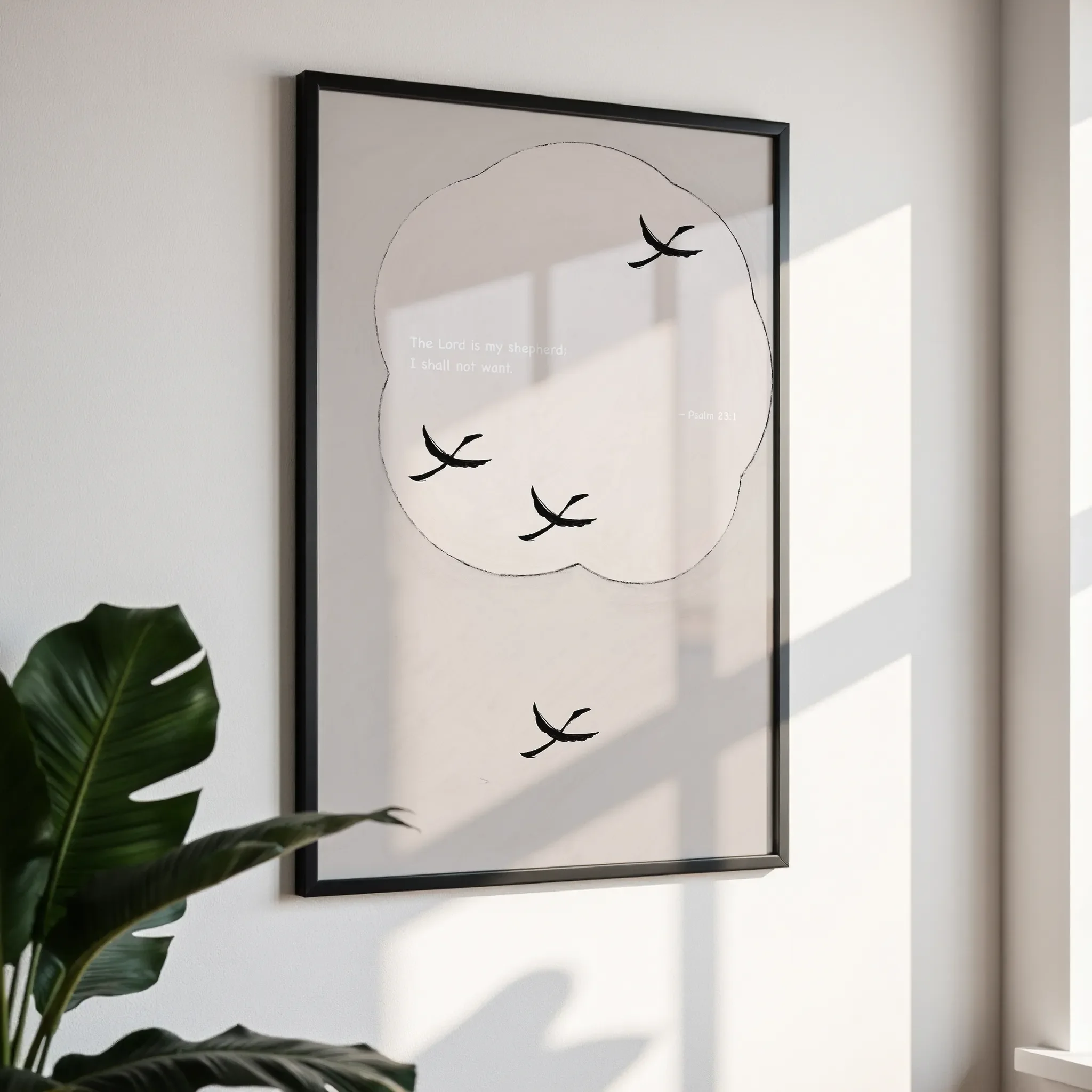Framed wall art in a simple black frame, photographed from an angled view against a white wall with direct sunlight.
