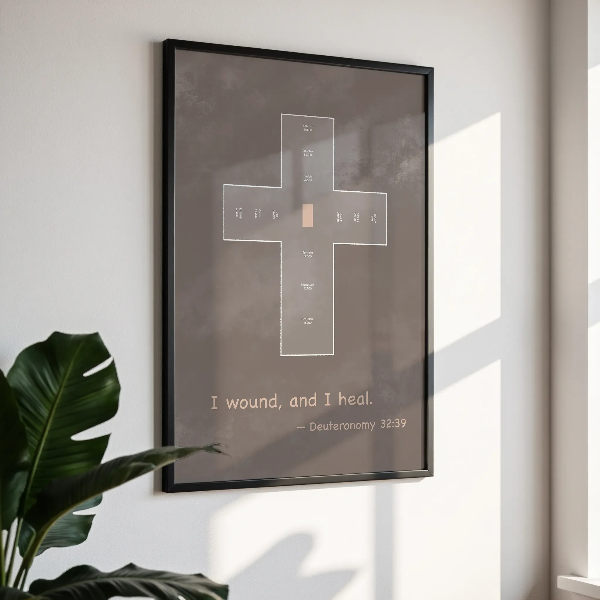 Framed wall art in a simple black frame, photographed from an angled view against a white wall with direct sunlight.