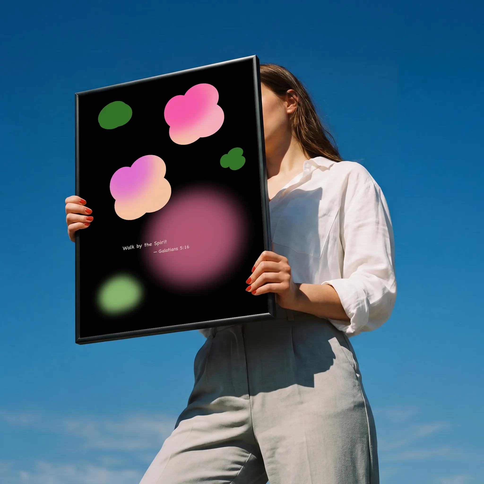 Held by a person in a white shirt outdoors under sunlight.