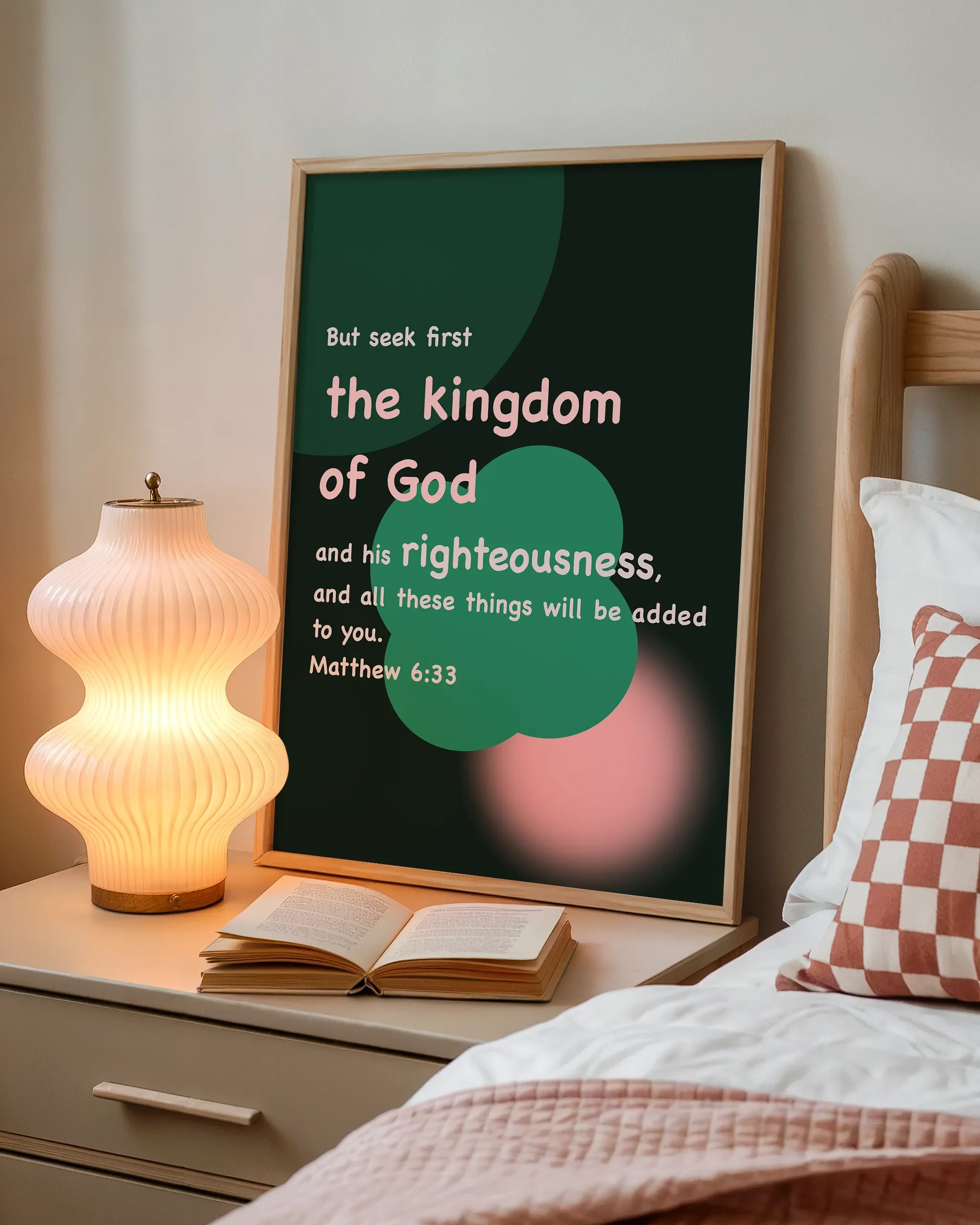 Displayed beside a wooden bed with a book and a softly glowing bedside lamp, creating a cozy atmosphere.