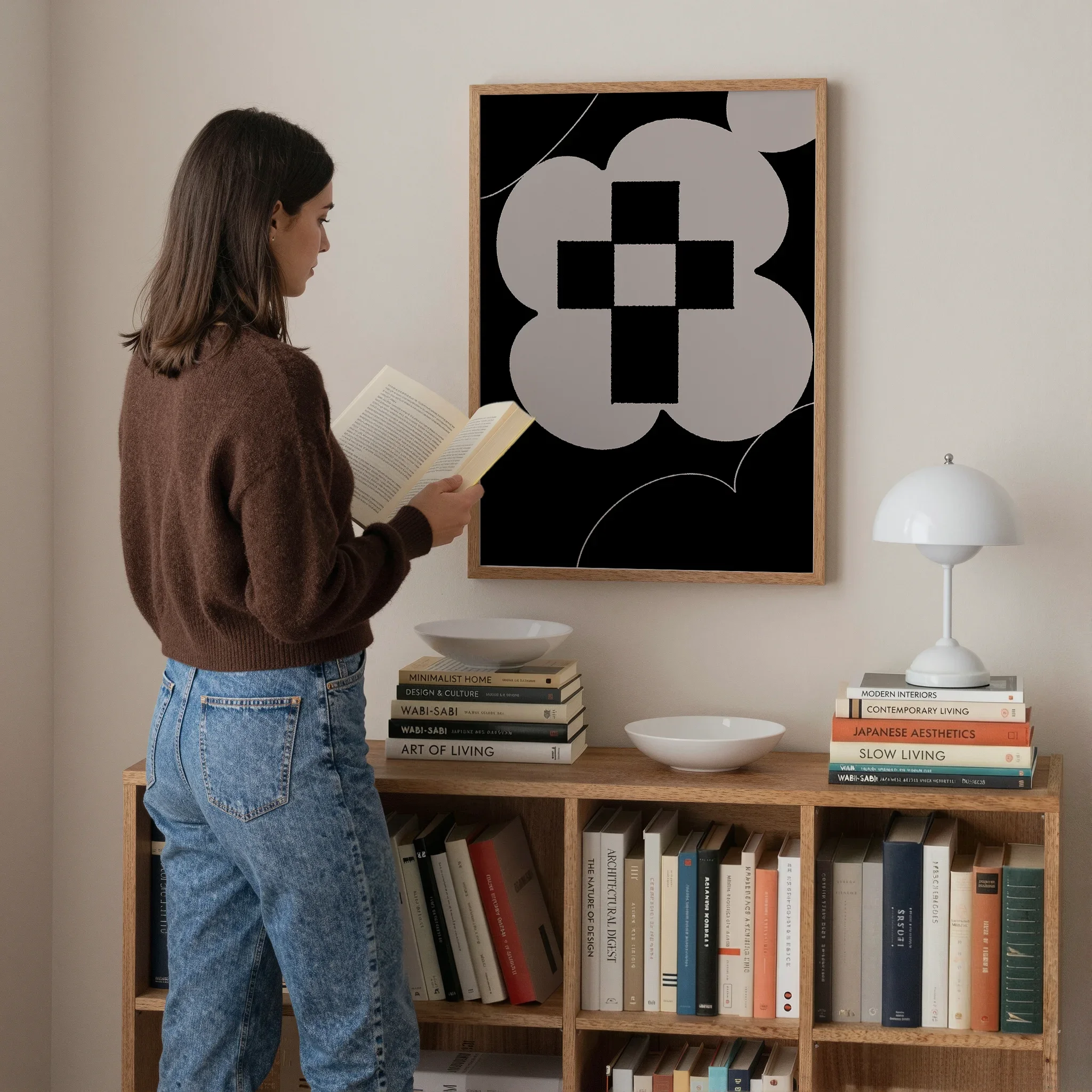 A Christian wall art print featuring cross art poster gentle floral design, shown above a bookshelf with a person reading nearby.