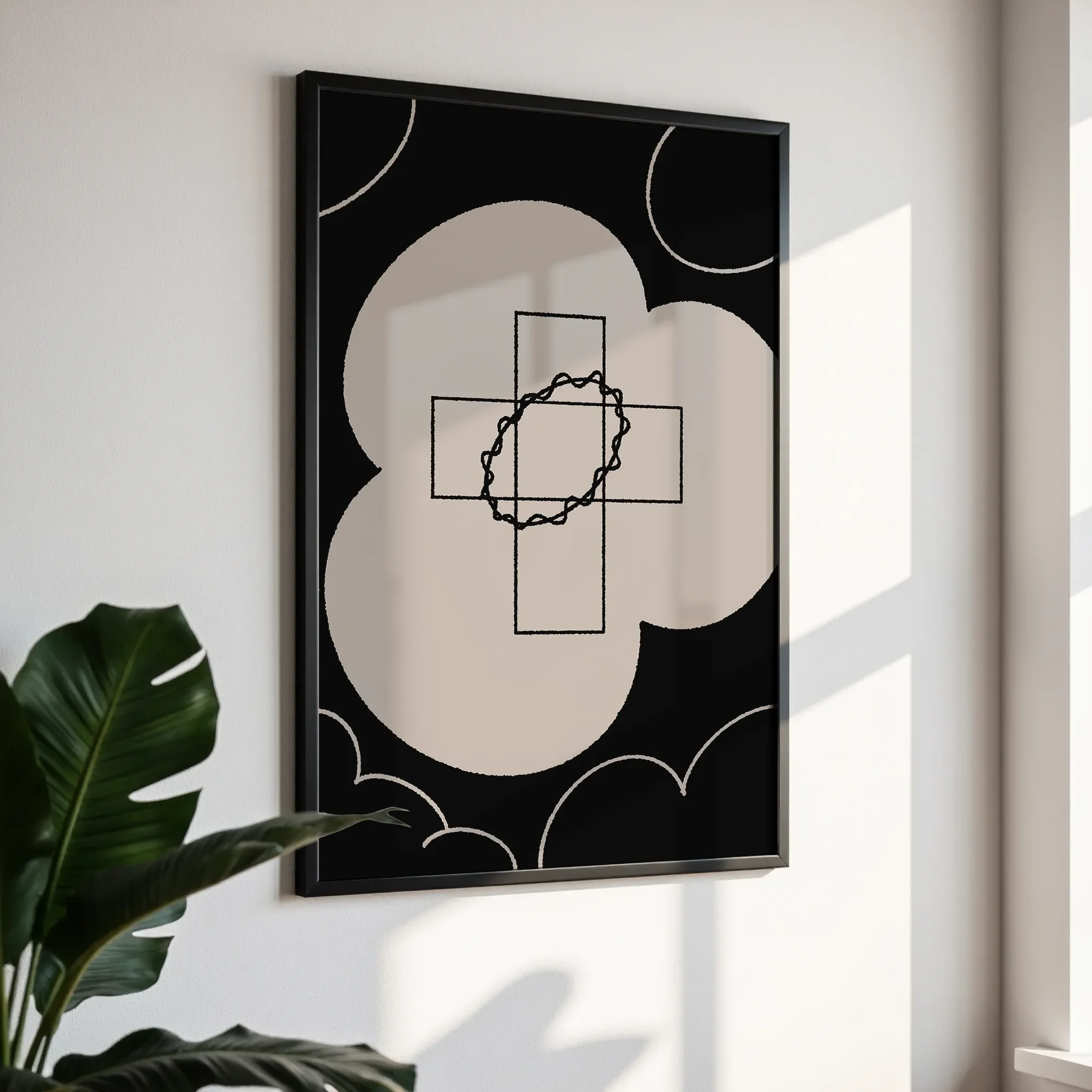 Framed wall art in a simple black frame, photographed from an angled view against a white wall with direct sunlight.