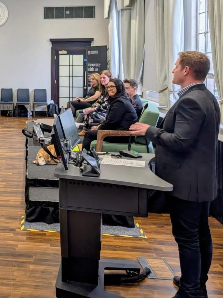 Professor Daniel Wheatley leading a panel discussion at the AI-empowered launch event in October 2025. 