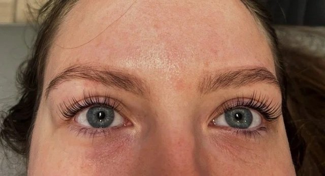 Close-up of a person's blue eyes and eyebrow area.