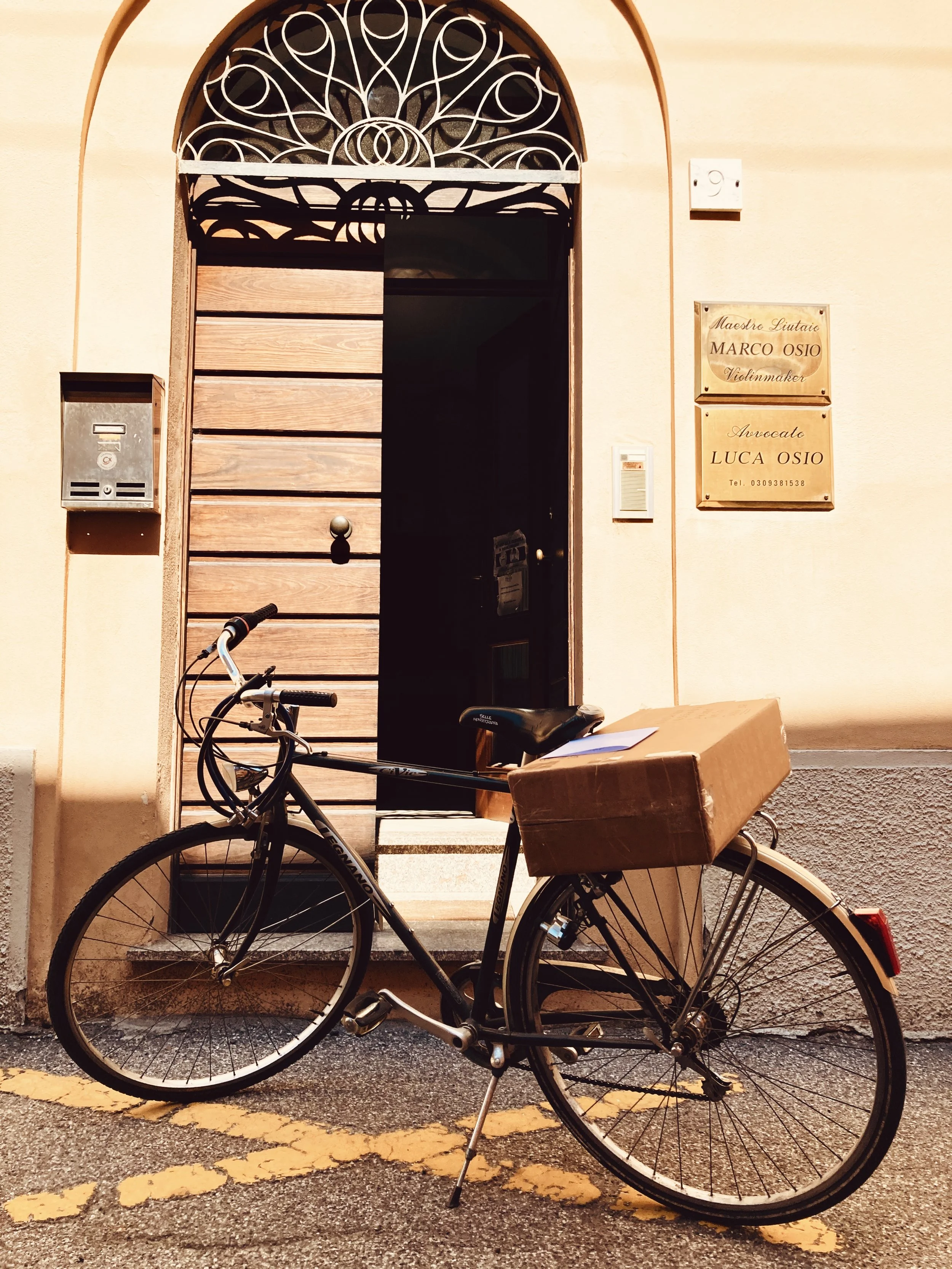 Bicycle outside the entrance to Marco Osio’s violin-making workshop in Cremona.