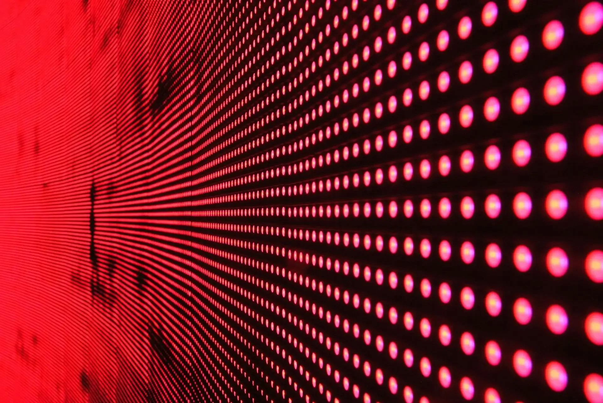 Close-up of a red electronic LED display panel with illuminated dots arranged in rows and columns.