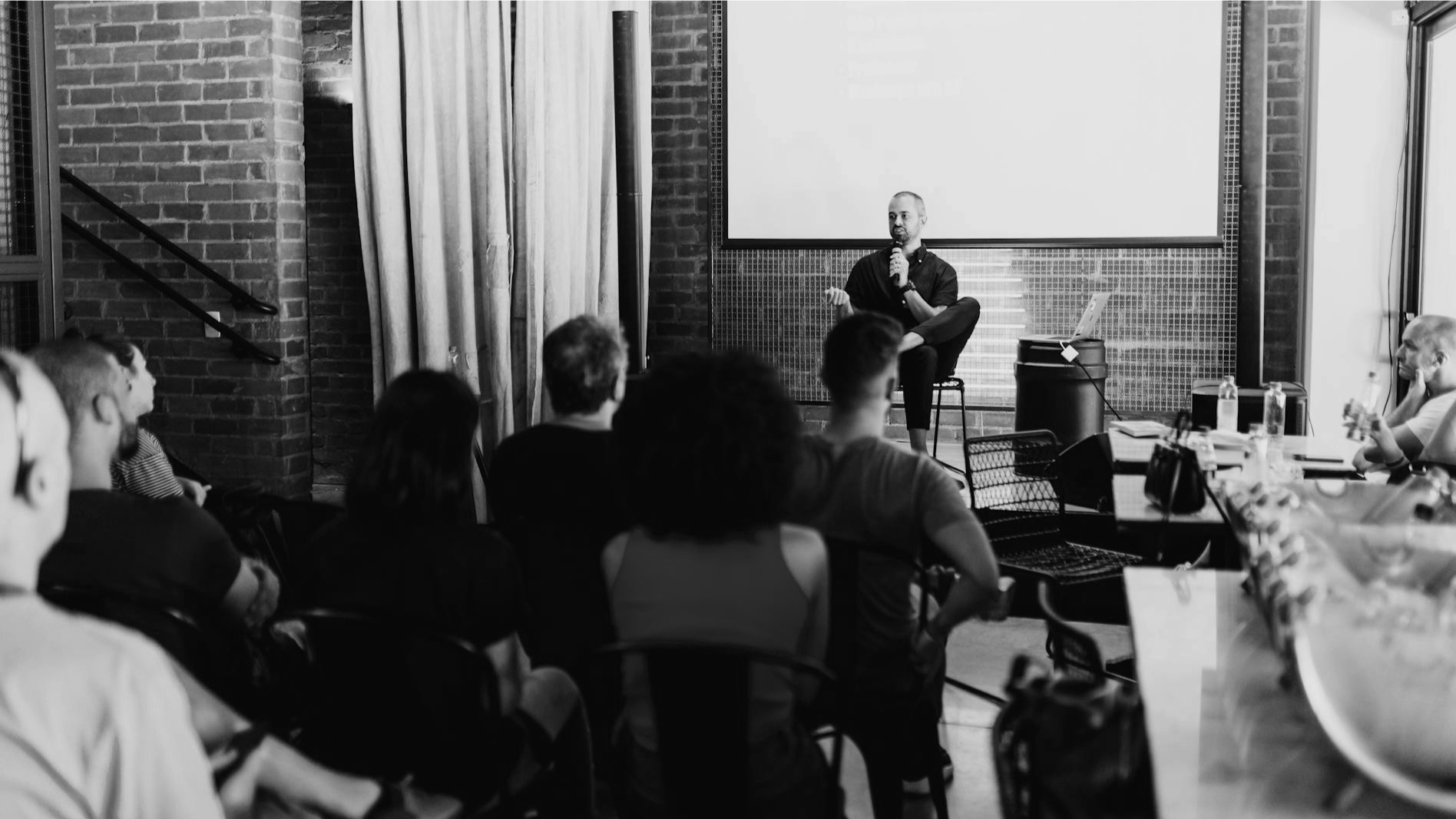 Photo Of masterclass where a man sitting In Front of group of people