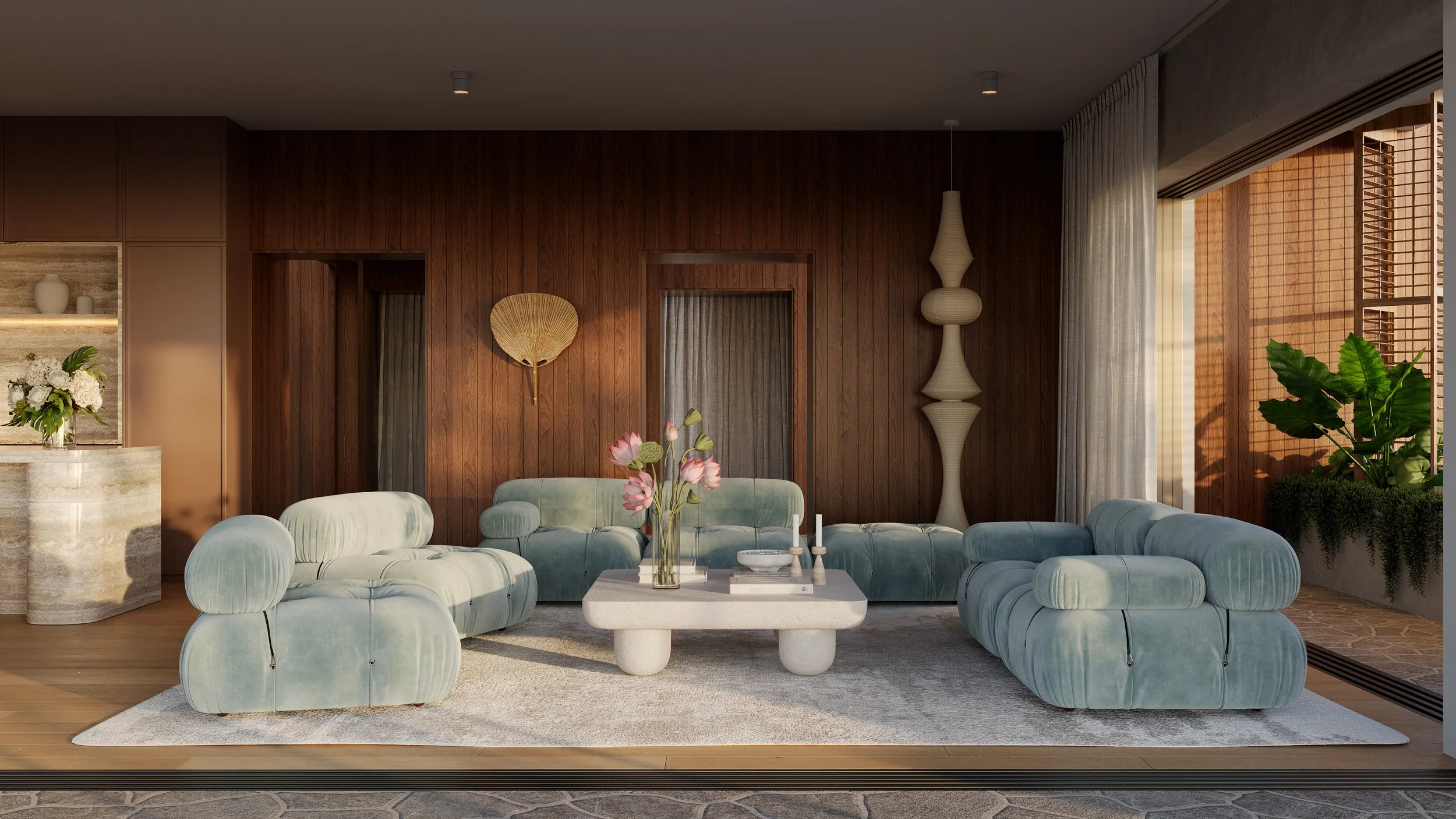 Modern living room with light blue velvet sofas, a white coffee table with pink flowers, a large window with view of balcony, wood-paneled wall, decorative lighting