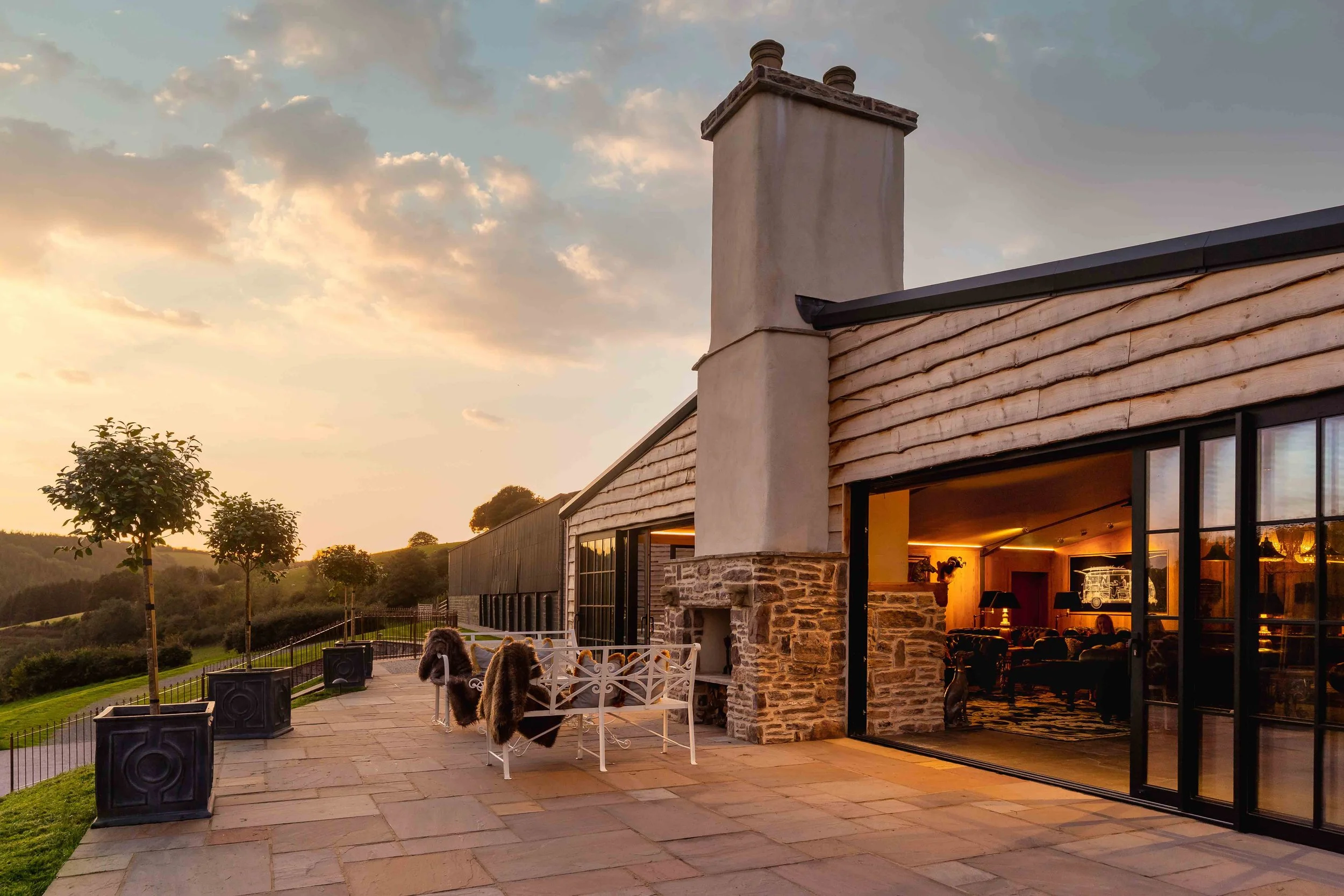 The side patio of Bittescombe Lodge at sunset.