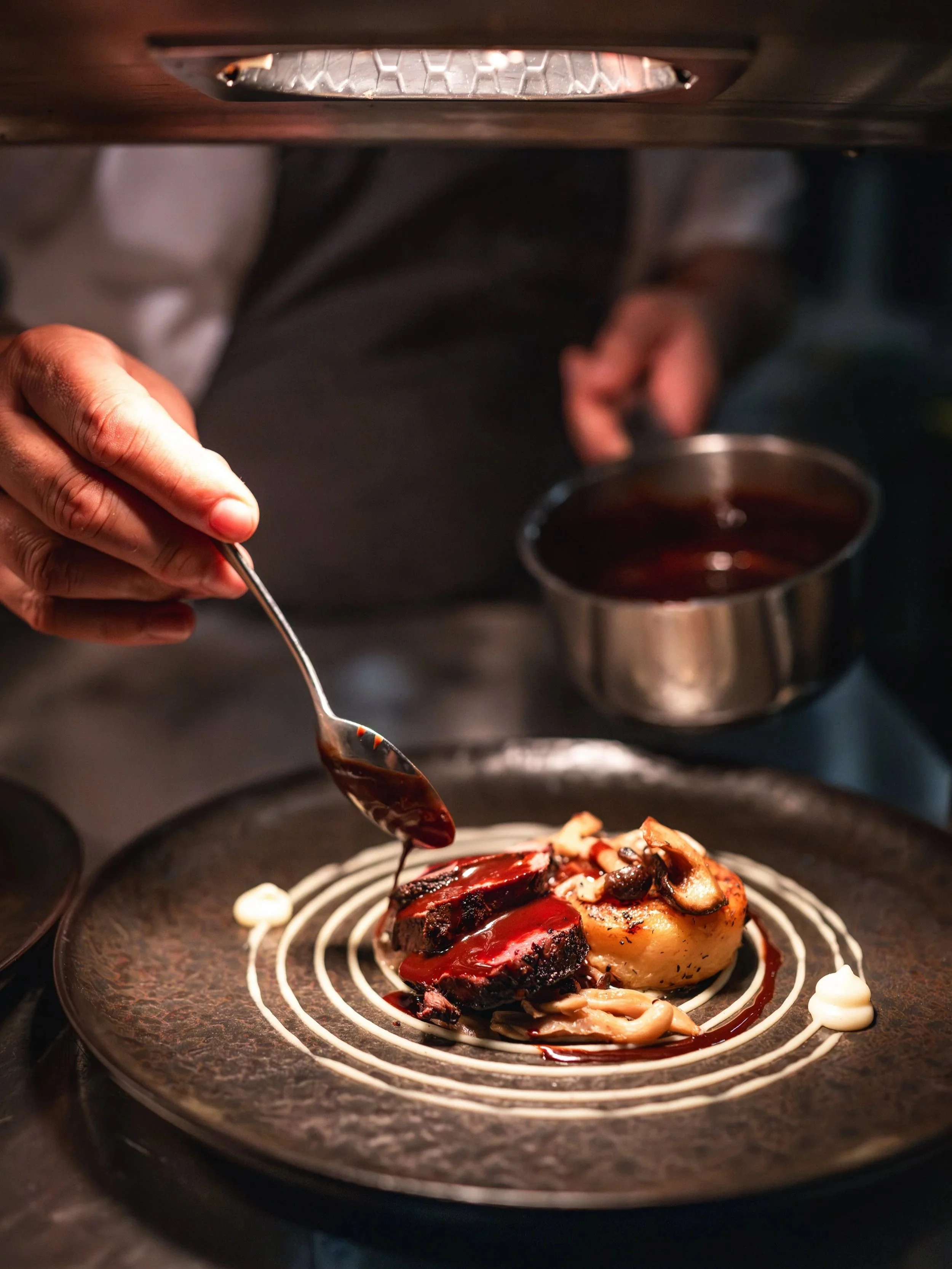 A Loyton private chef preparing a gourmet meal for a shooting party dinner.