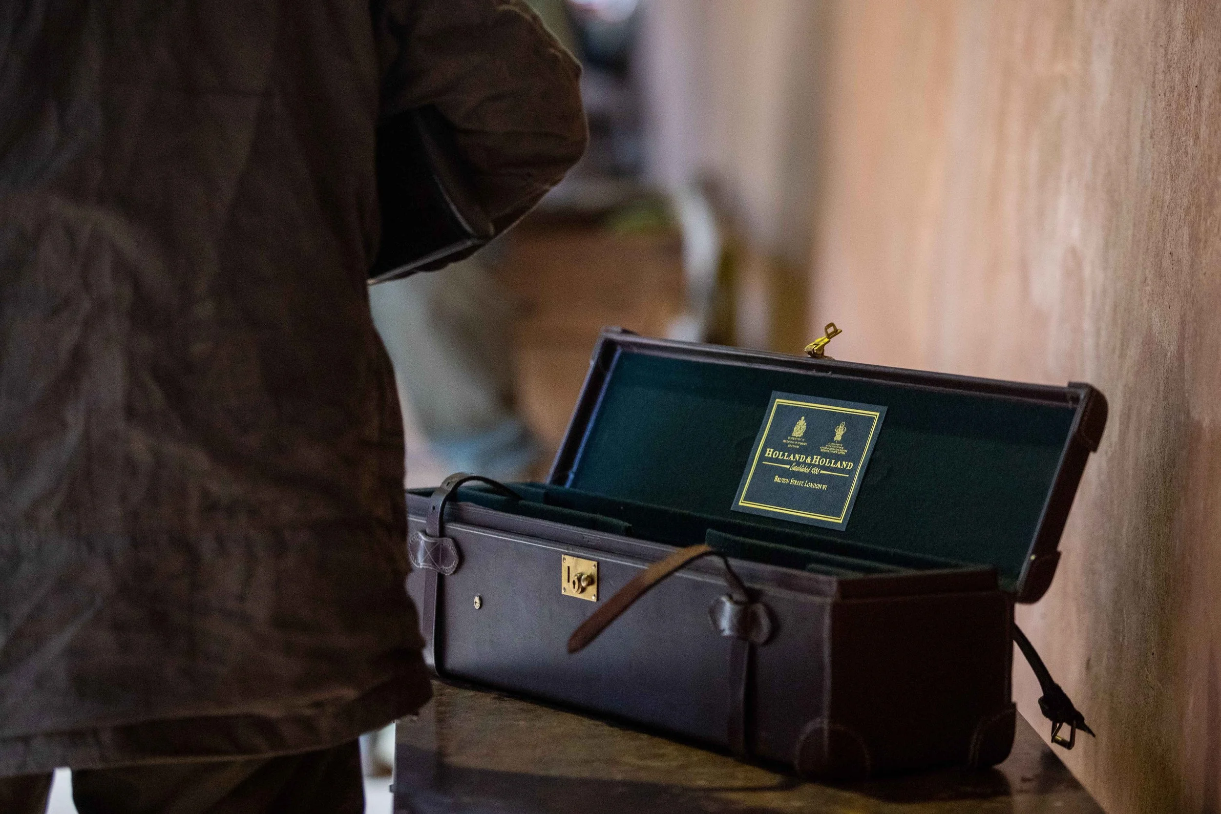Holland & Holland leather gun case resting on a table in the Loyton Lodge gun room.