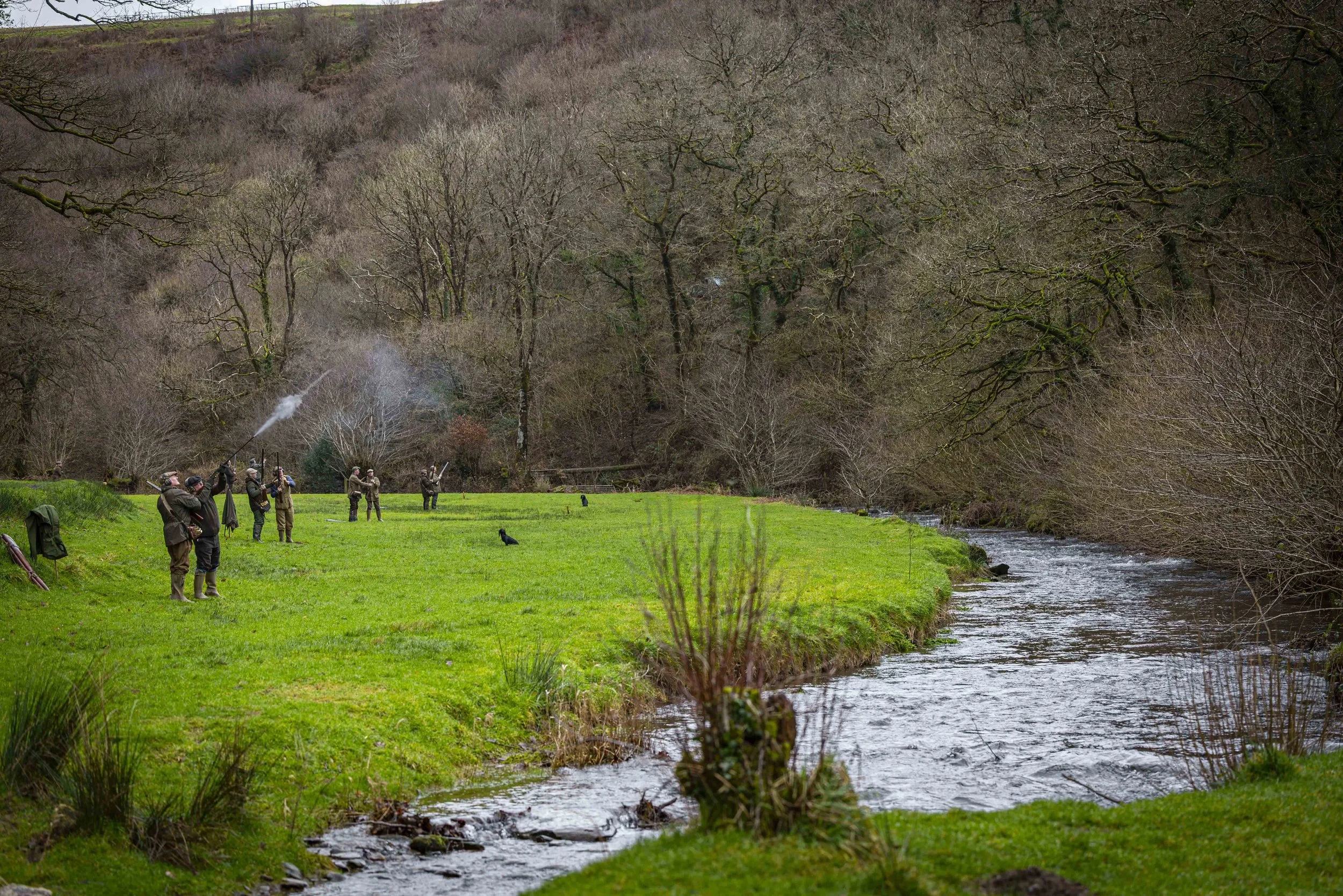 Guests firing shotguns on an embankment during a drive at Challacombe.