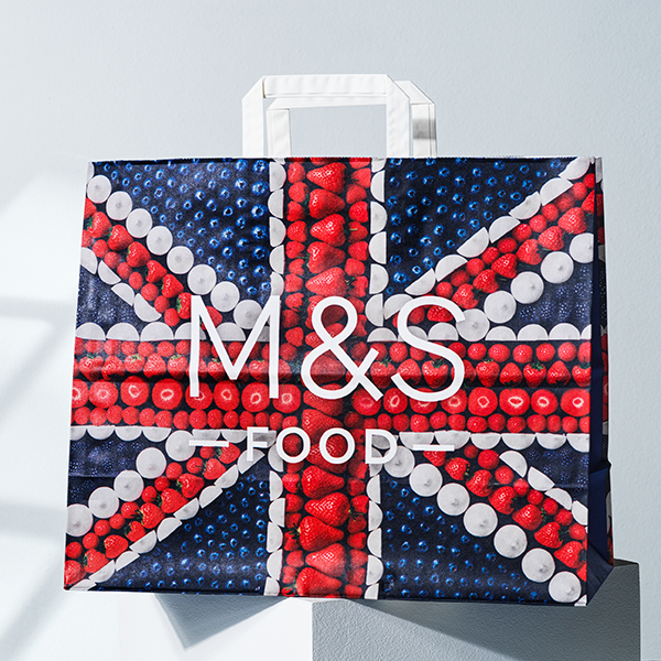 Full colour printed paper bag with flat handles, perfect for branded retail packaging.