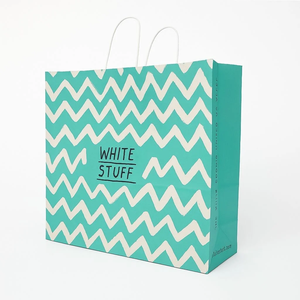 Side view of turquoise paper bag with twisted handles, perfect for premium retail presentation.