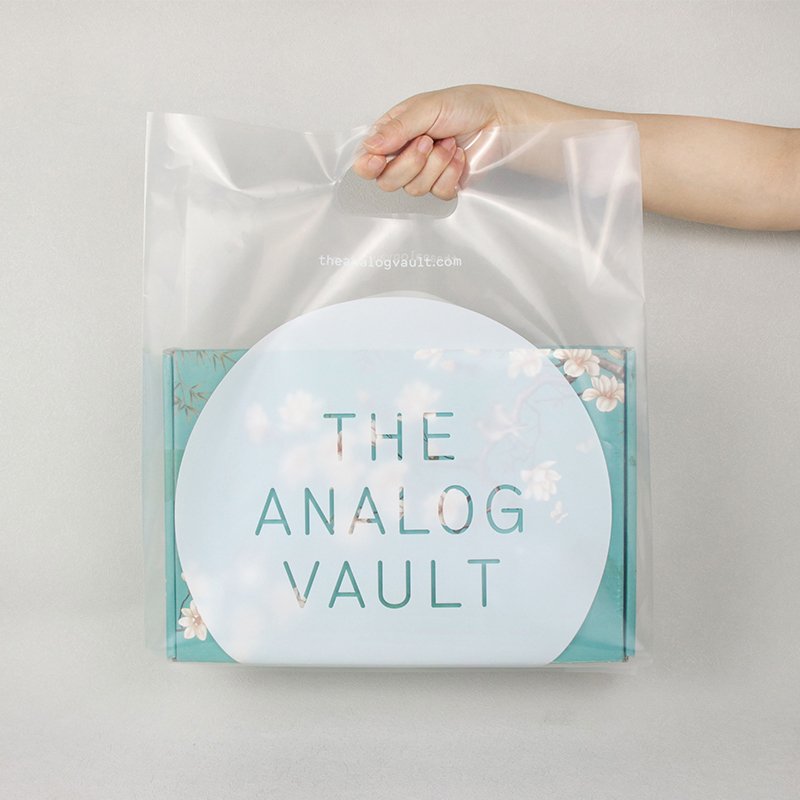 Large clear polythene carrier bag with punched handle and white print, ideal for branded retail packaging.