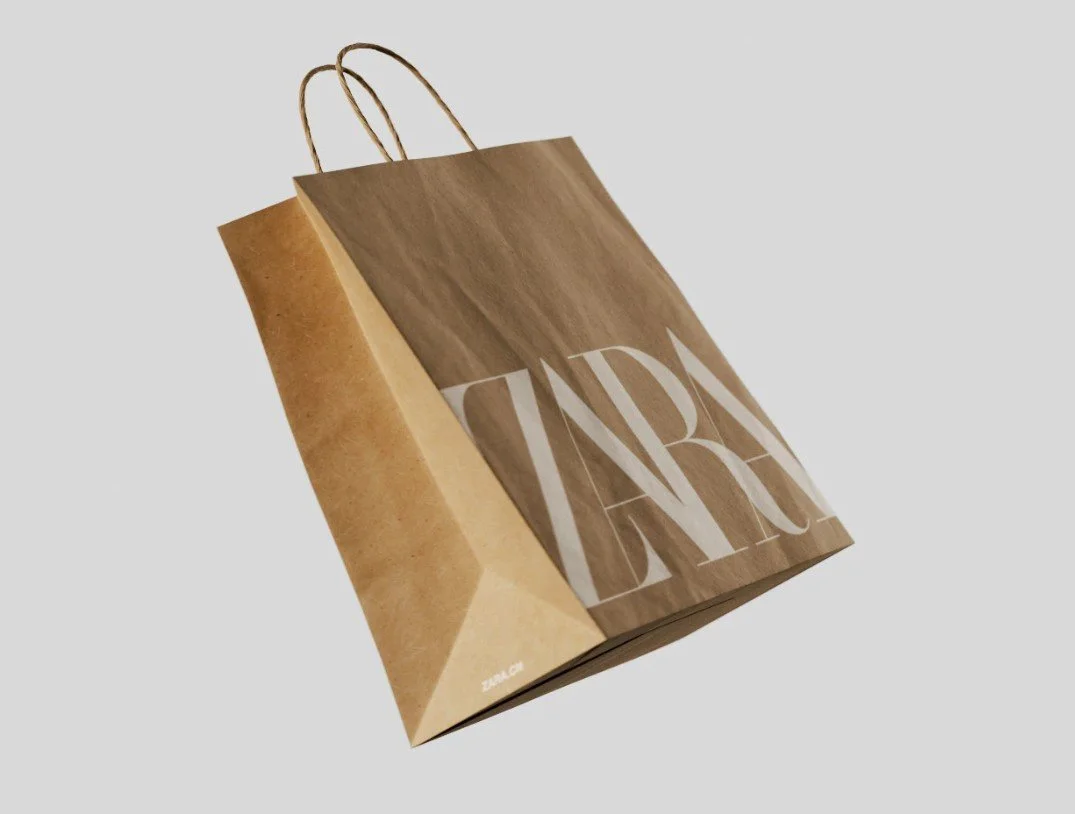 Brown kraft paper bag with twisted handles and white logo, ideal for sustainable retail packaging.