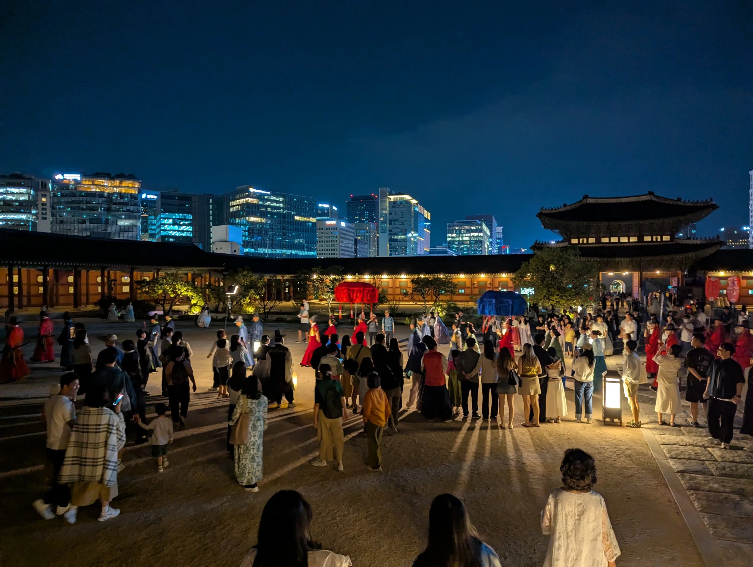 Procession at Gyeongbokgung palace of people dressed in hanbok at night