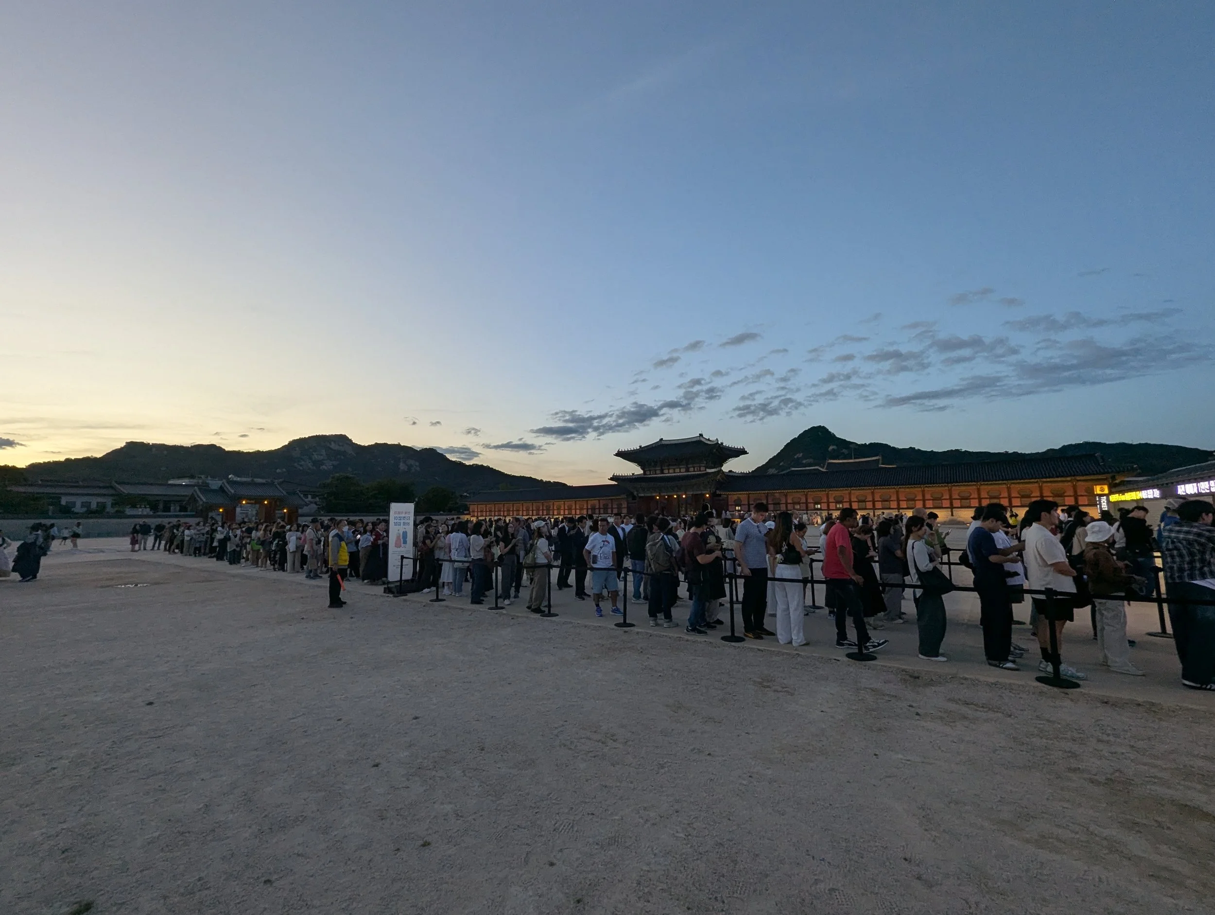 Line of people in front of Gyeongbokgung ticket office at night