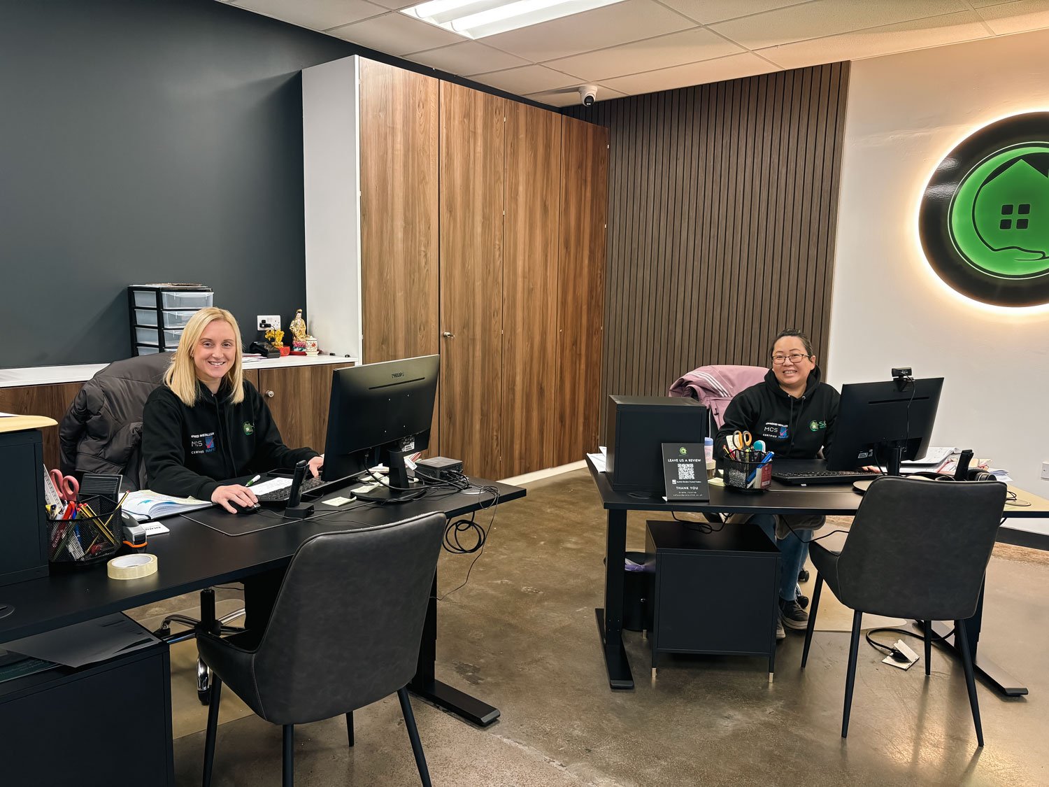 S&P Renewables Galashiels. Customer services team, Diane & Becky pictured against the S&P Logo in the Galashiels showroom