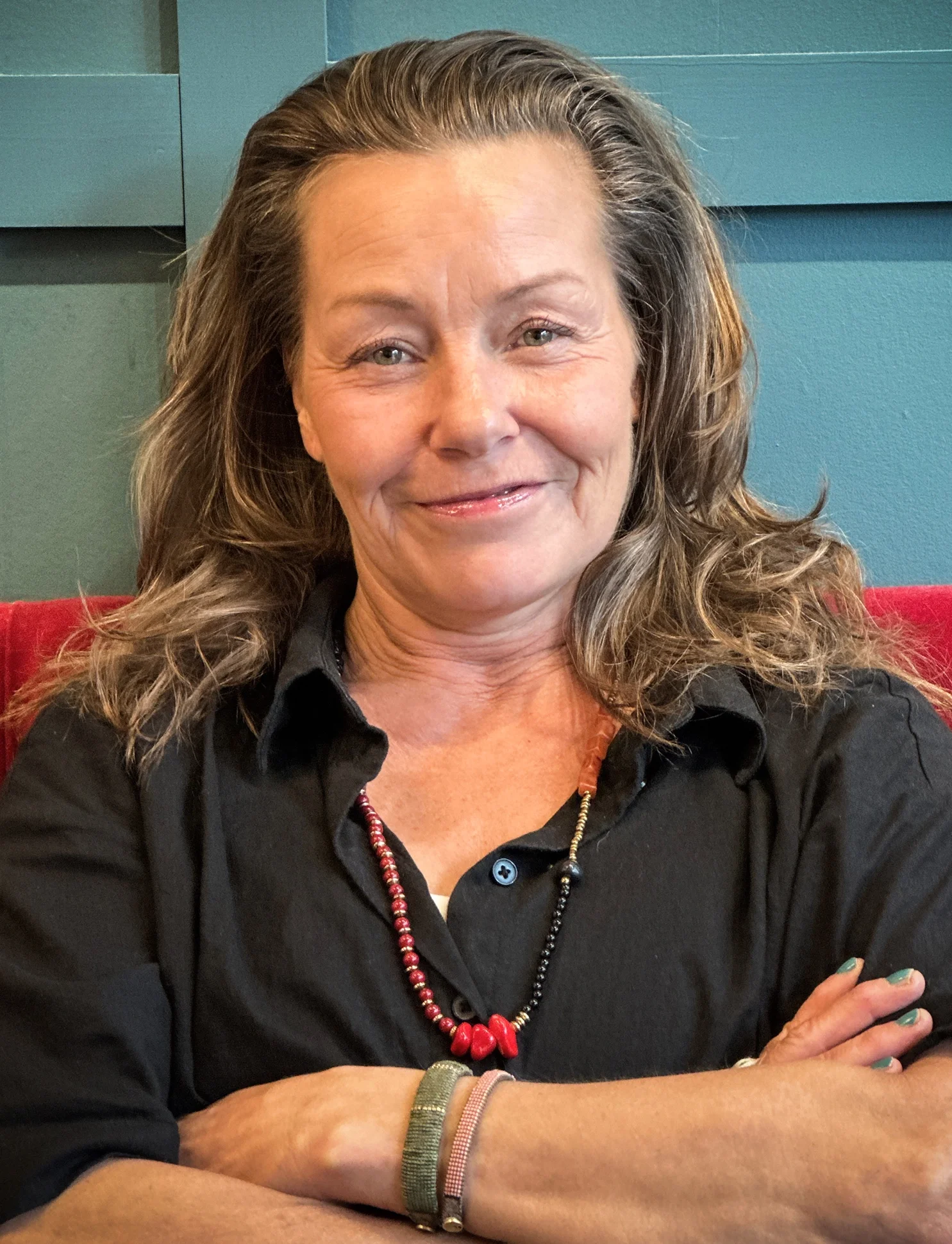 gotland pictures film casting - middle aged woman smiling in to the camera. She has brown hair and is wearing a black shirt