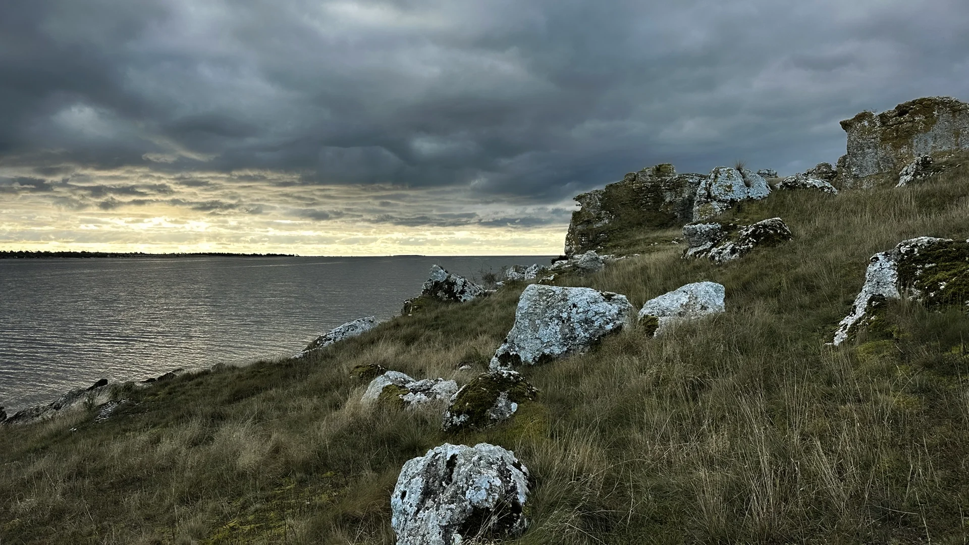 Film Location in Gotland - Grassy steep slope, dark low clouds in the sky