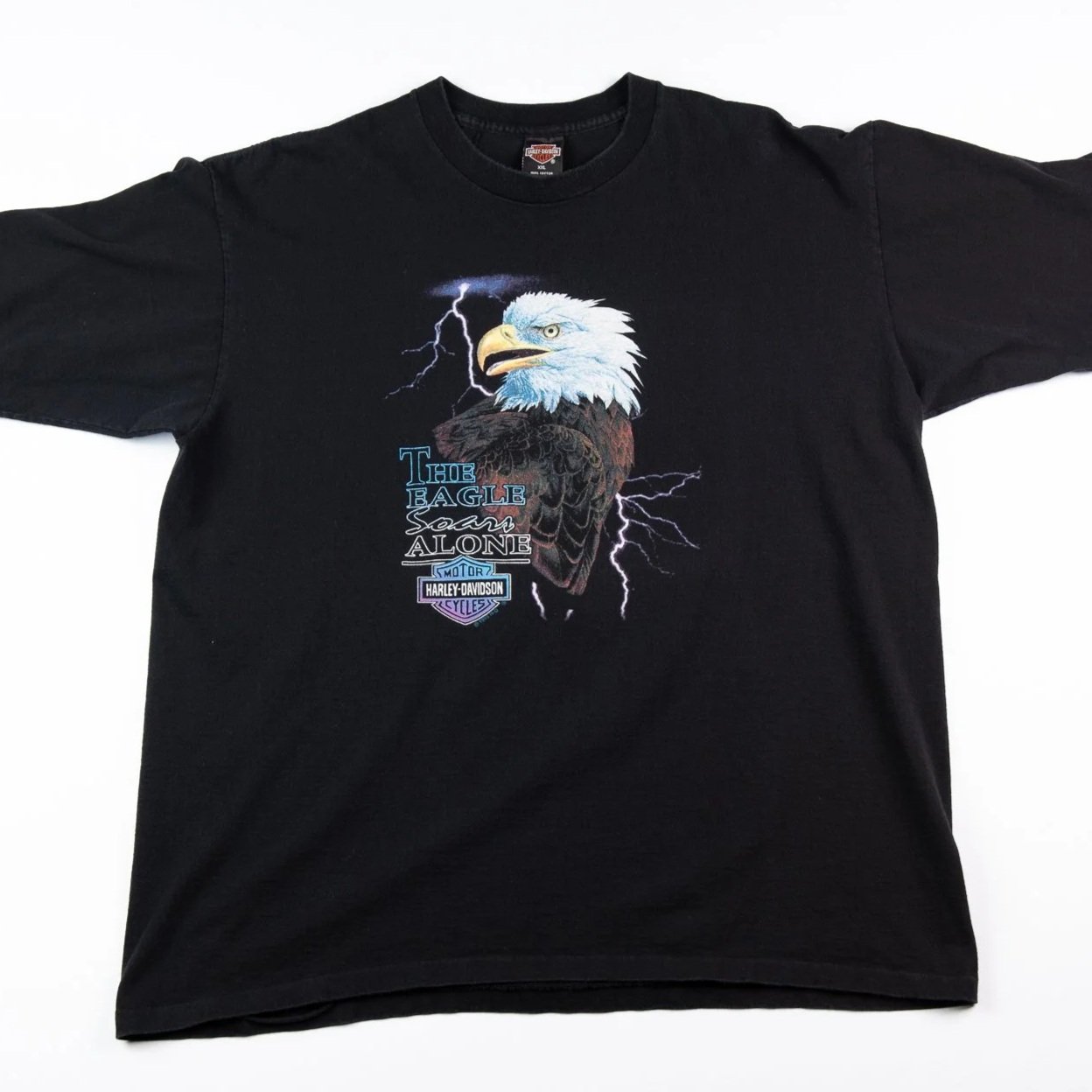 Black T-shirt with an eagle graphic, lightning bolts, and Harley-Davidson logos and text.