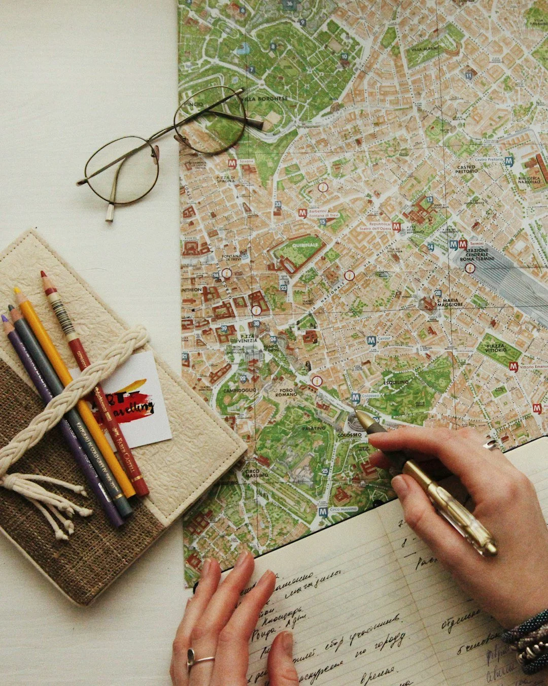 Paper map, notebook and travel essentials on a table