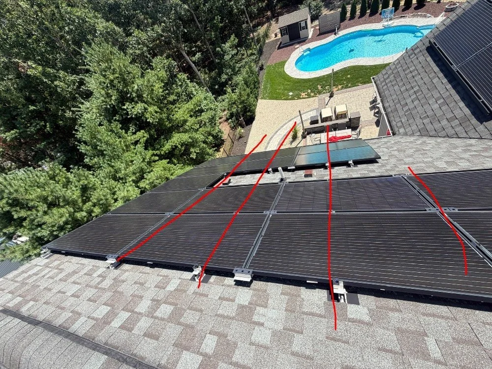 Solar panel inspection in Barnegat NJ showing rooftop array mounts aligned in non-staggered columns