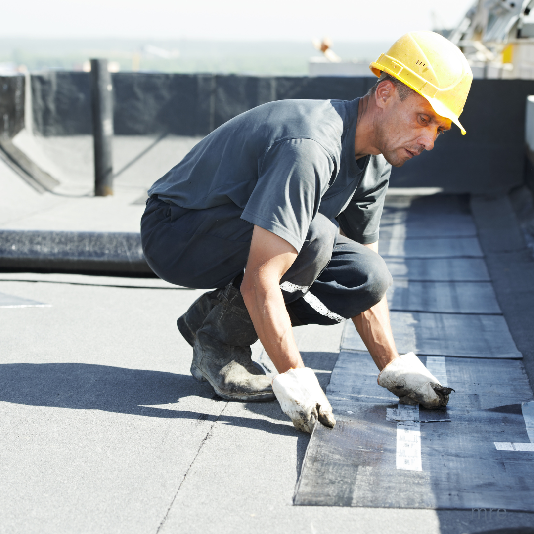 Commercial roofing contractor installing flat roof membrane in Tulsa, Oklahoma
