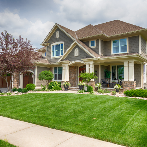 Two-story suburban home with well-maintained lawn and landscaping in Tulsa, Oklahoma