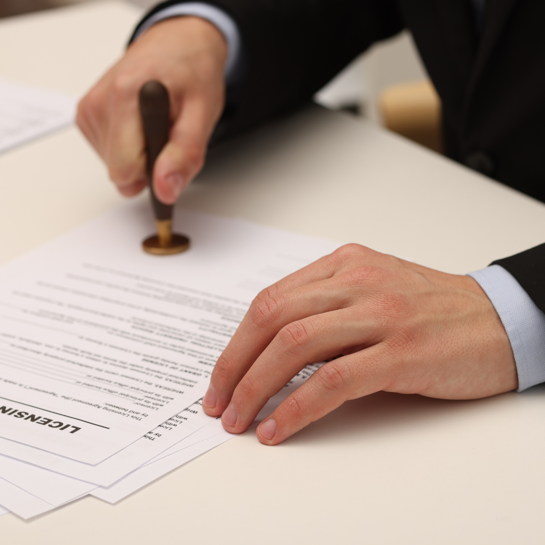 Person in a business suit stamping a document labeled "LIEN" with a stamp.