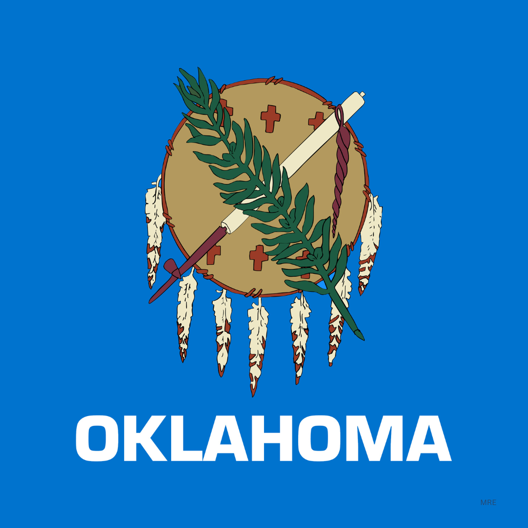 Oklahoma state flag featuring a traditional Native American shield with a green olive branch and a crossed arrow, with the word 'OKLAHOMA' below.