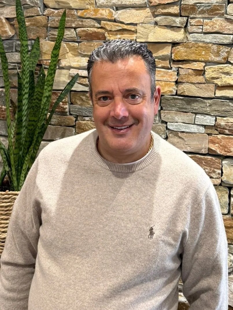 A smiling man, wearing a grey jumper, the managing director of San Remo