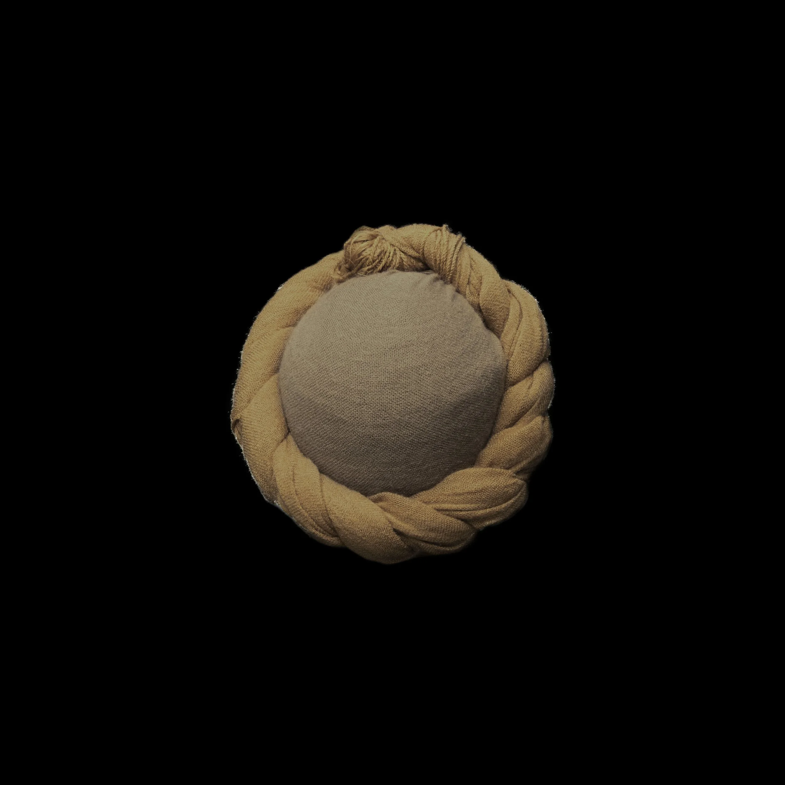 A black background with a round object at the center. The object has a smooth, beige, fabric cover and is surrounded by a thick, braided, beige cord or rope looped around it.