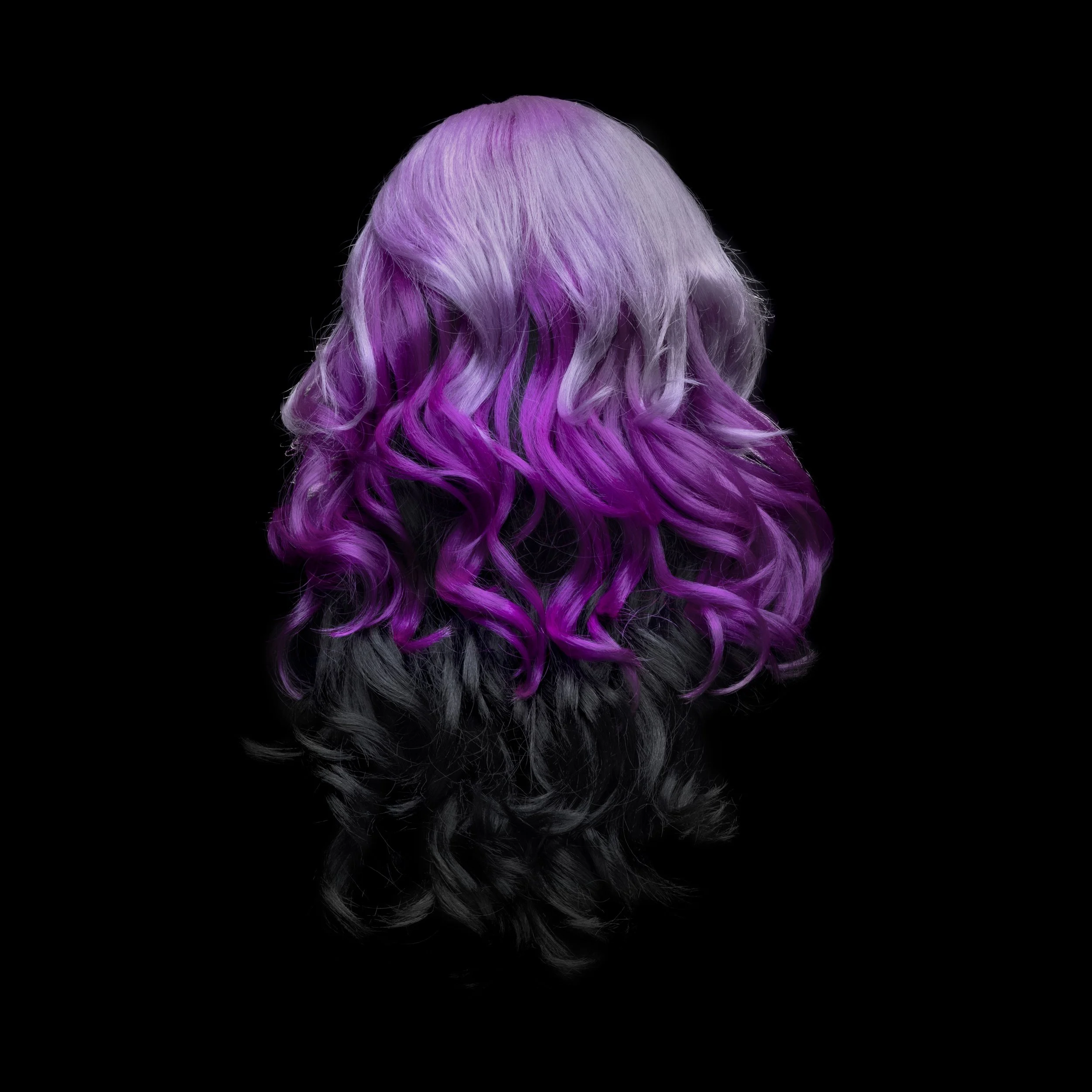 Back of a person's head with wavy hair dyed in a gradient from platinum blonde to purple to black, against a black background.