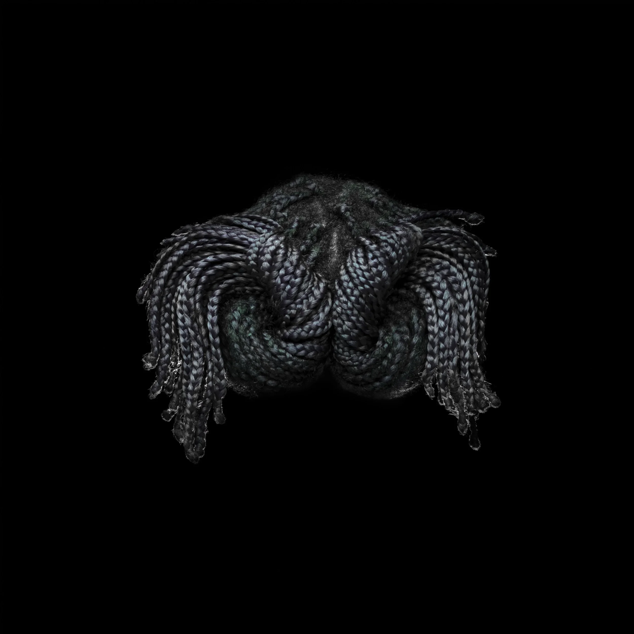 A pile of gray and black braided hair extensions with some green highlights, arranged in a twisted shape against a black background.