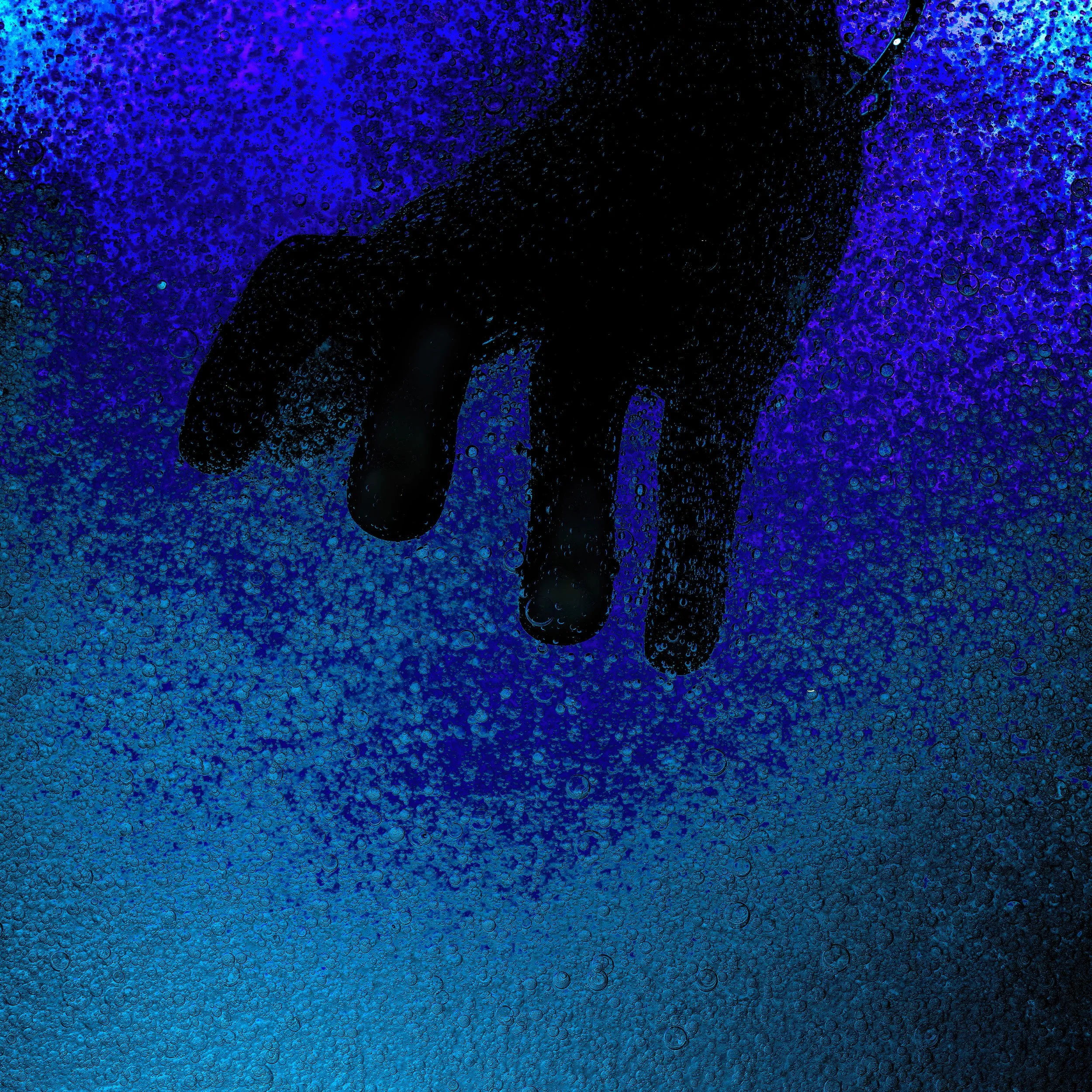 A dark silhouette of a hand reaching downwards against a vibrant blue and purple background with water droplets.