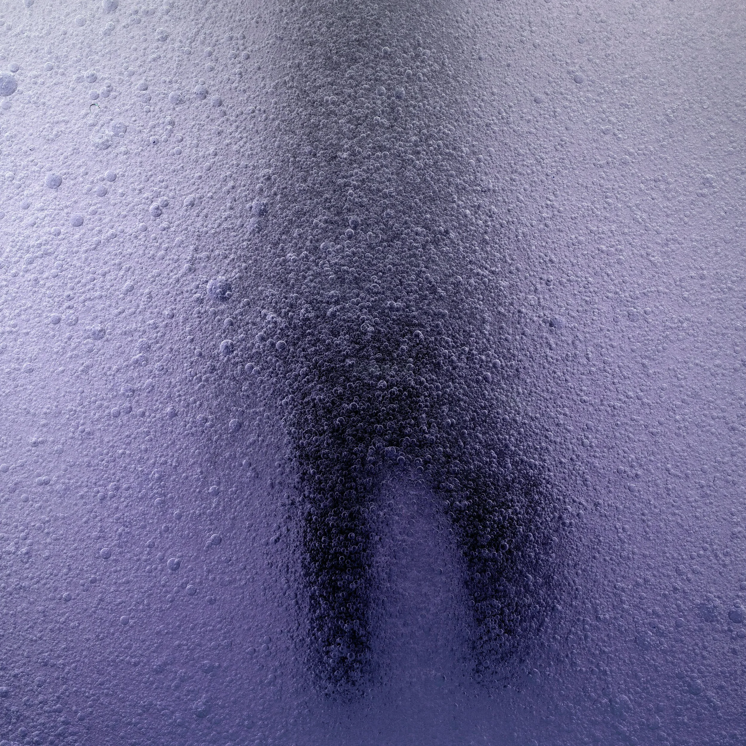 A silhouette of a person seen through a foggy, frosted glass surface.
