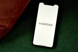Smartphone displaying the Substack app logo on a green surface.