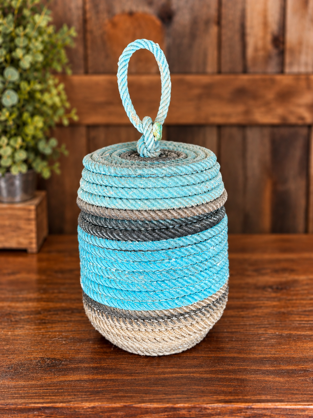 Handcrafted Aqua Rope Basket on Rustic Wood.png
