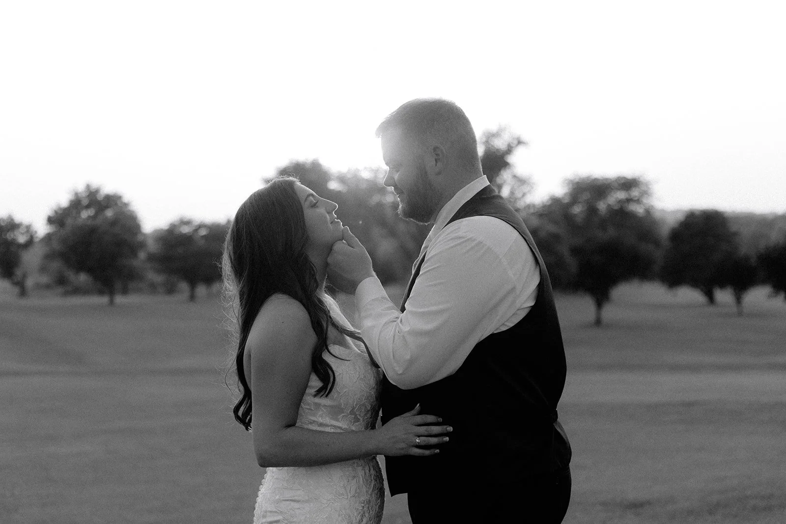 Bride and groom sharing a quiet embrace during outdoor wedding portraits photographed by Northern Illinois wedding photographer Nicole Kilday