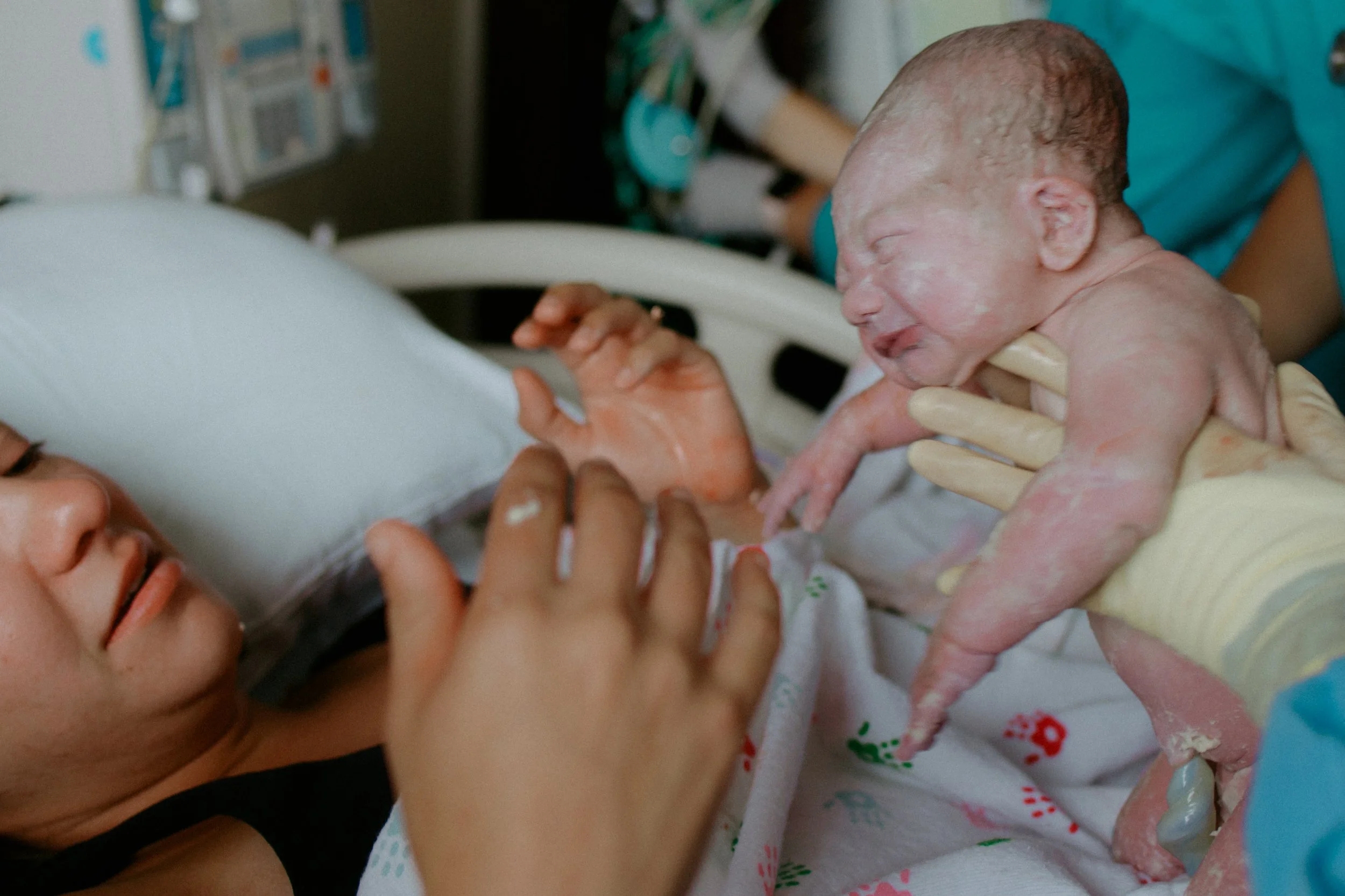 A mom reaching for her son in his first moment of life post delivery in McHenry County Illinois by Nicole Kilday