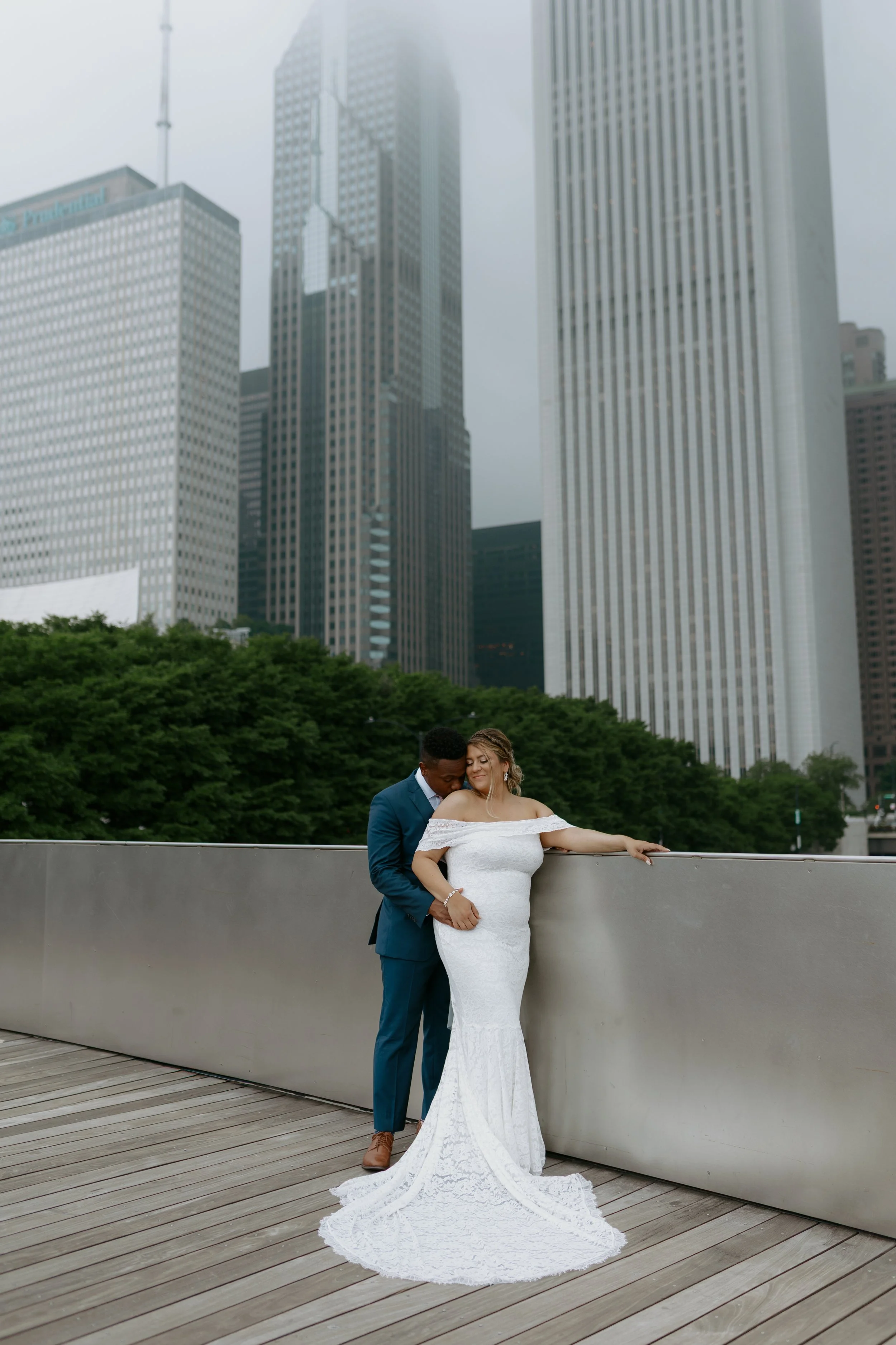 Bride and groom sharing an intimate moment in front of the Chicago skyline post ceremony at their elopement by Nicole Kilday Photography