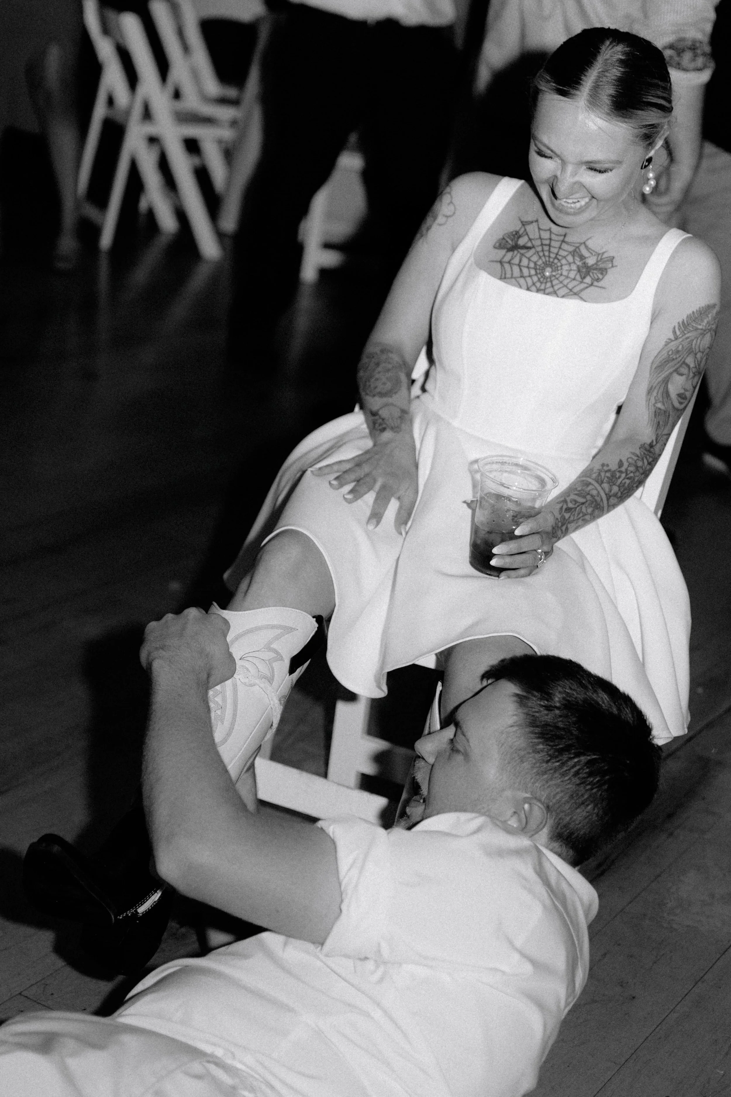 Bride laughing with her groom during wedding reception at Bluestem Farm and Events in Hebron Illinois, documentary wedding photography by Nicole Kilday
