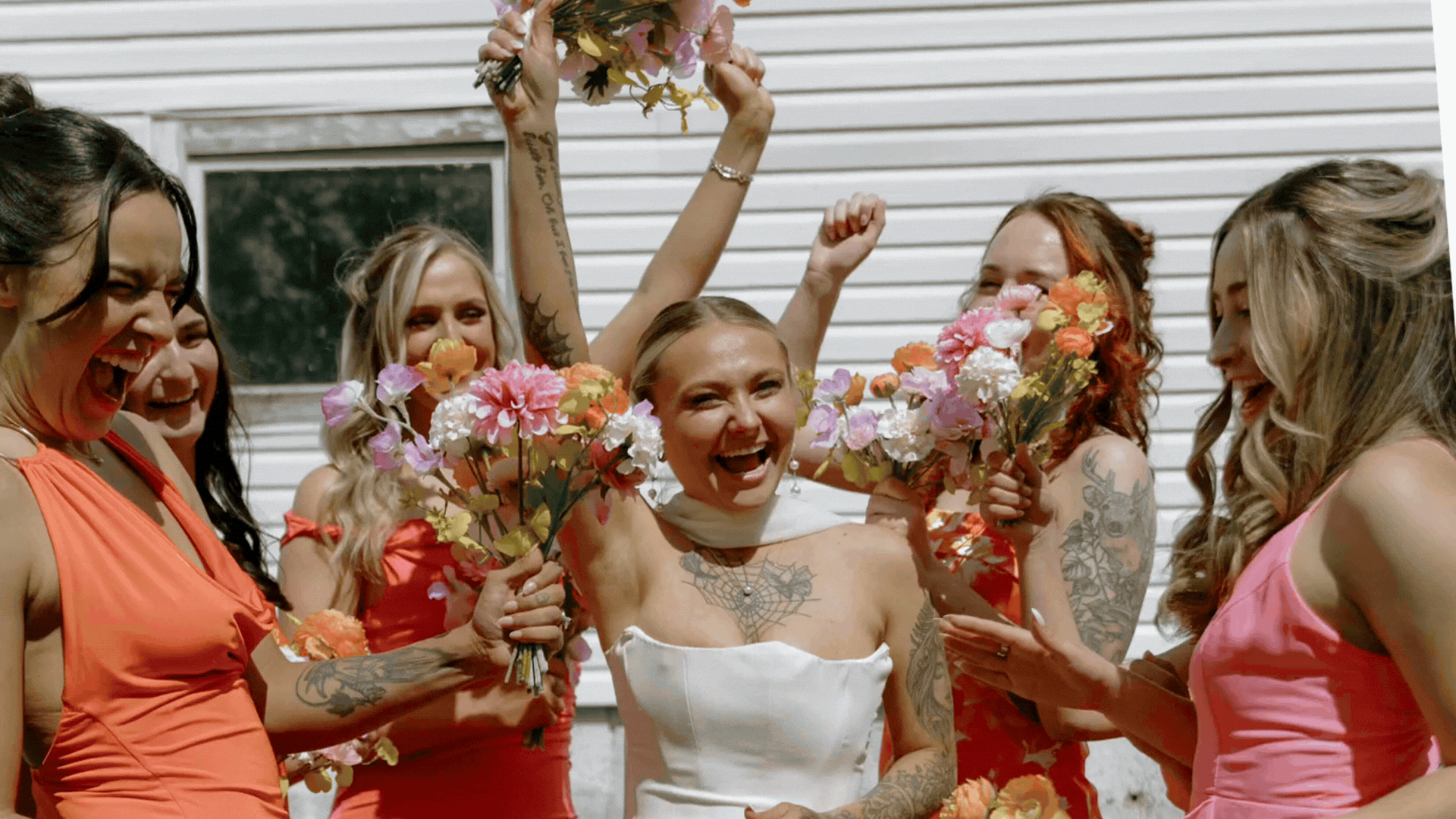 Bride celebrating with bridesmaids holding colorful bouquets photographed by McHenry County Illinois wedding photographer Nicole Kilday