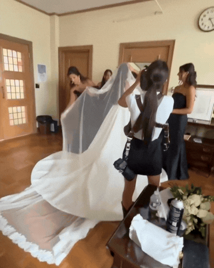 McHenry County Illinois wedding photographer Nicole Kilday working during bridal prep, photographing a bride putting on her veil before the ceremony