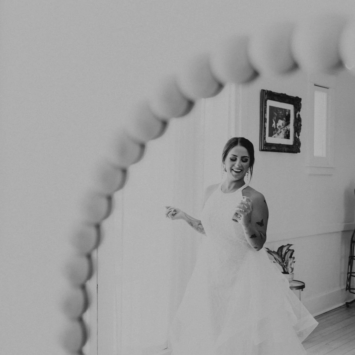Bride getting ready for a destination wedding in Saint Peters, Minnesota, photographed in a candid black and white style by a traveling wedding photographer