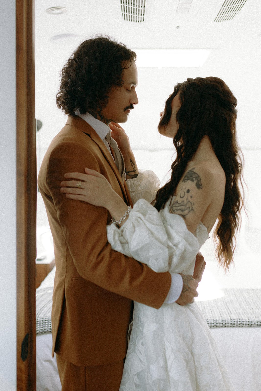 Couple sharing a quiet moment together while getting ready before their micro wedding ceremony in Boston, photographed by Nicole Kilday