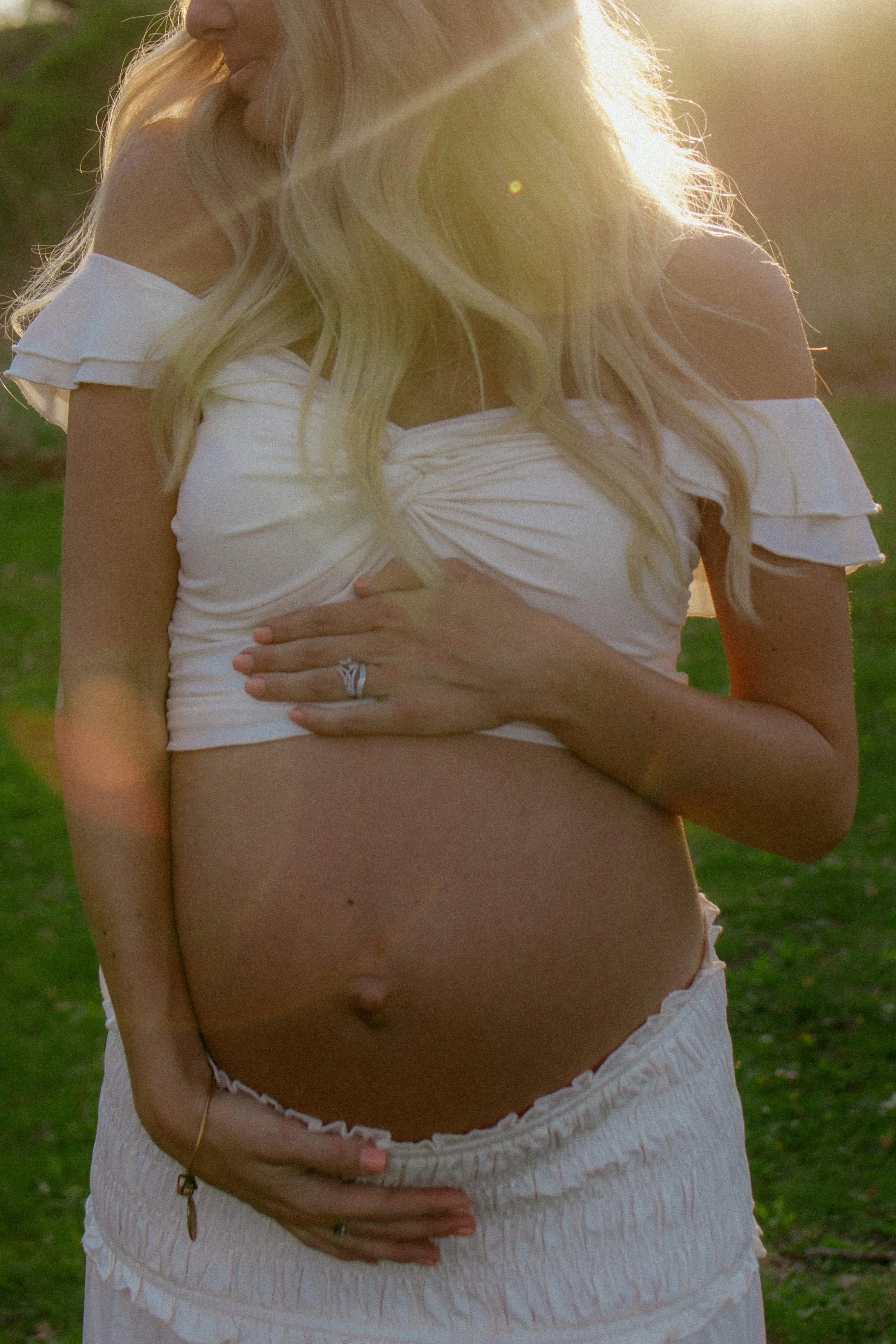 Documentary maternity photography session in McHenry County, Illinois featuring an expecting mother outdoors during golden hour.