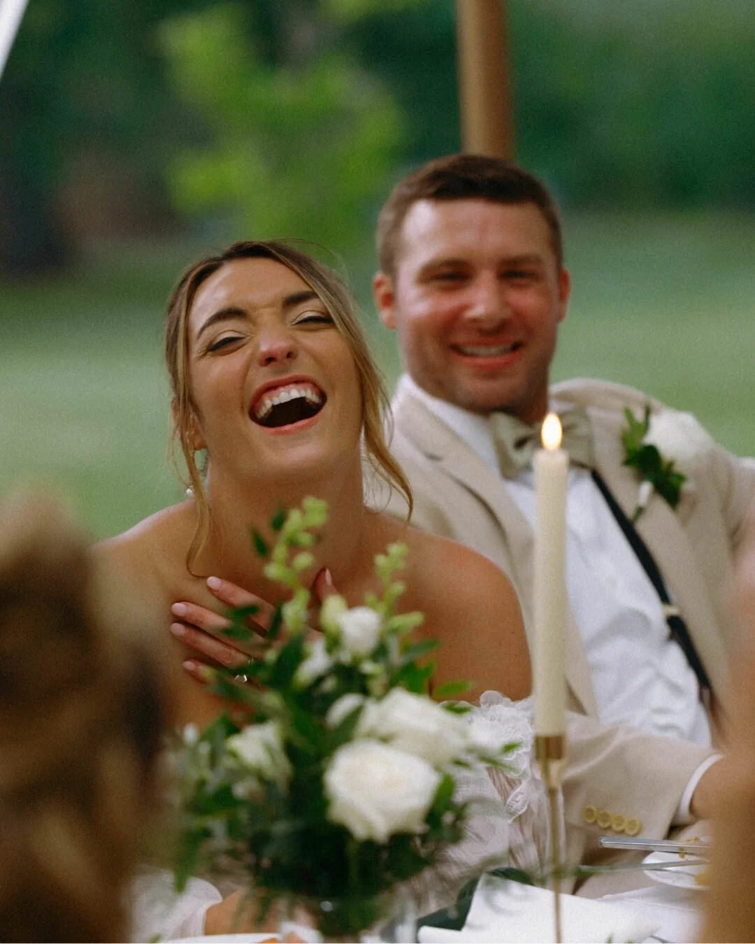 Bride and groom laughing together during their Chicago Illinois wedding reception, candid wedding photography by Nicole Kilday